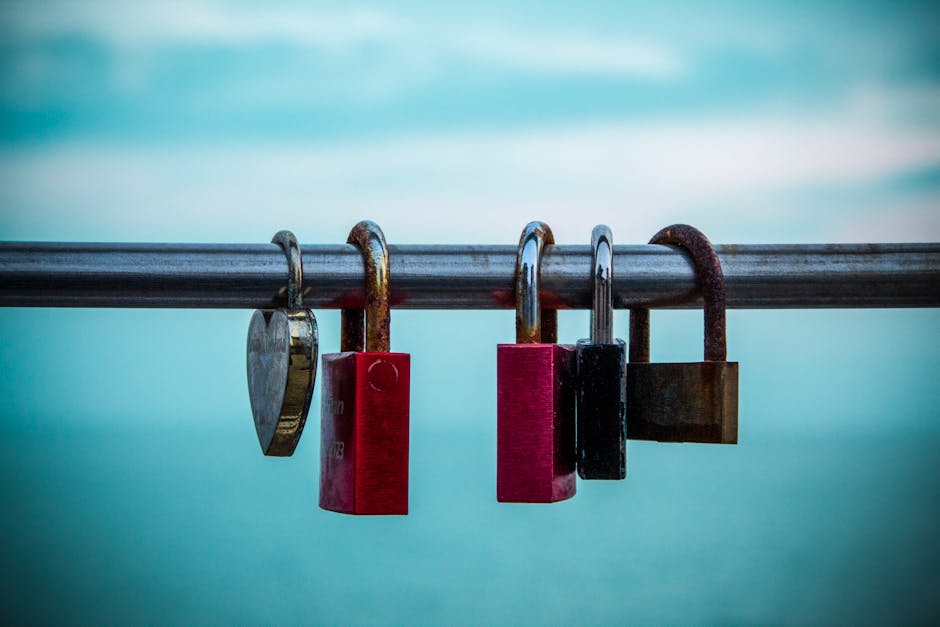 Lovelocks hanging on a rail in Grado, Italy, symbolizing love and commitment with a sea backdrop.
