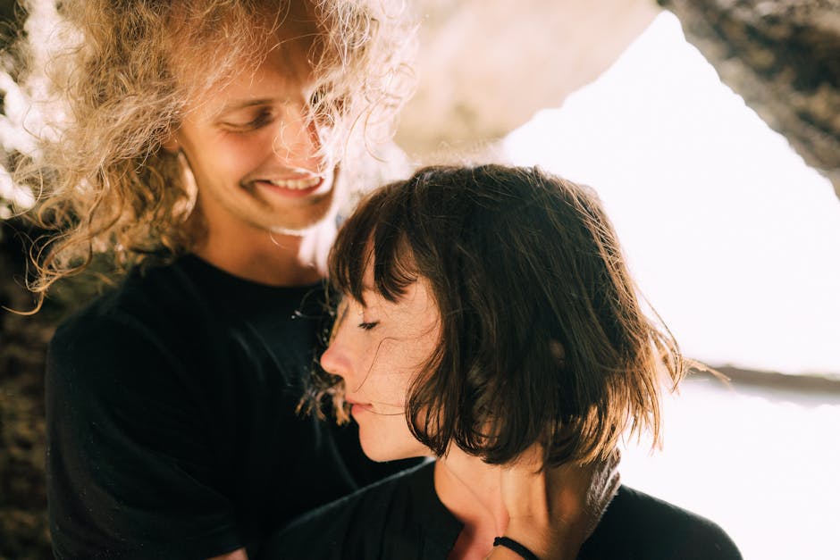 Couple embracing in a warm, natural light setting, symbolizing love and affection.