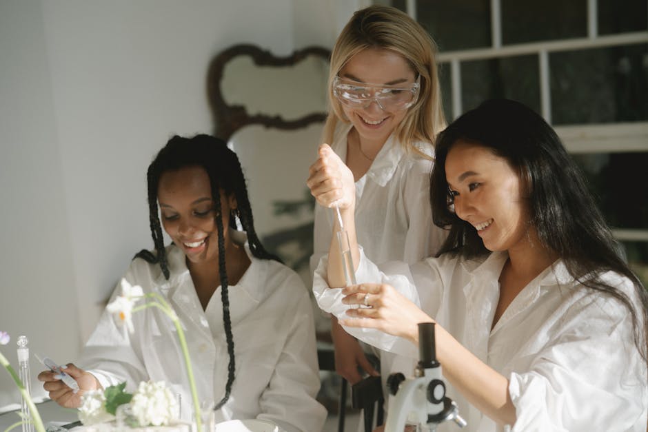 Three women engaging in a science experiment with lab equipment and test tubes.