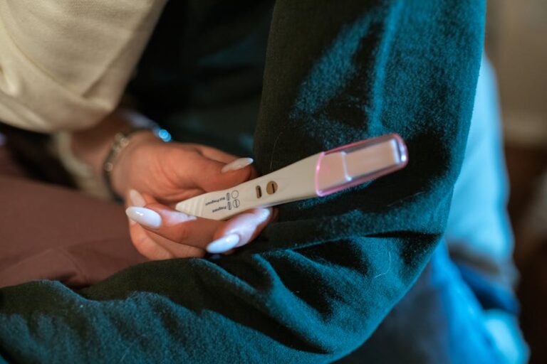 A woman's hand holding a positive pregnancy test, symbolizing hope and new beginnings.