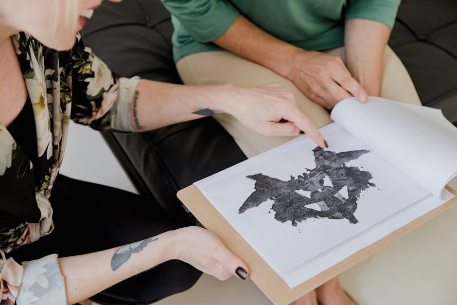 Two adults discuss a Rorschach inkblot test, focusing on interpretation and analysis.