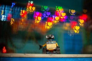 Toy robot with colorful bokeh heart shapes and 'I Love You' text, creating a whimsical atmosphere.