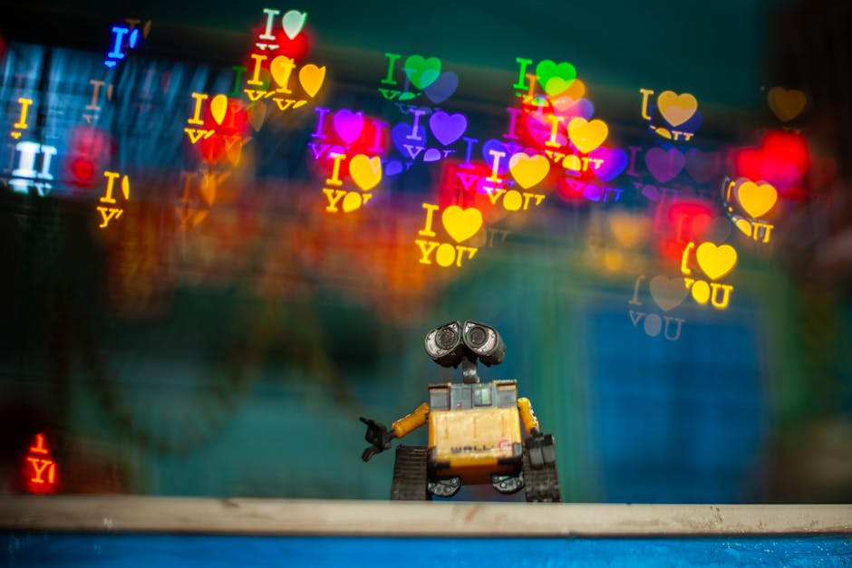 Toy robot with colorful bokeh heart shapes and 'I Love You' text, creating a whimsical atmosphere.