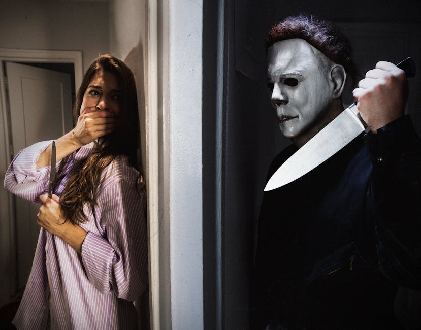 Dramatic horror scene featuring a masked figure and frightened woman indoors.