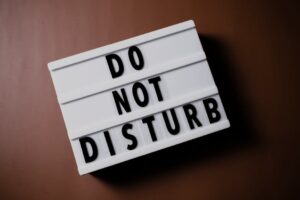 Minimalist lightbox displaying 'Do Not Disturb' message on brown background for focus and privacy themes.