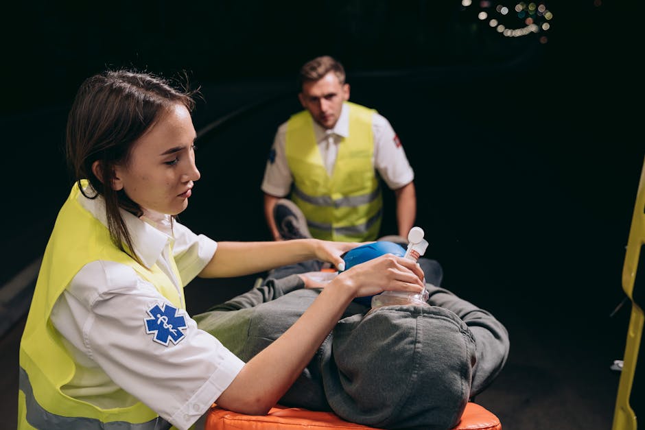 Paramedics provide critical care to a patient during a nighttime emergency response.