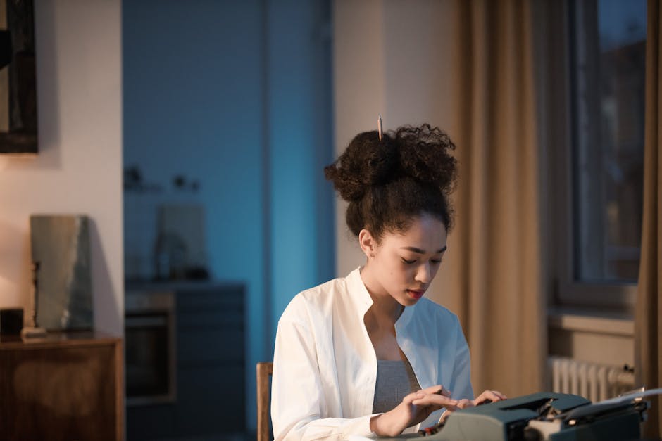 Young woman typing on a vintage typewriter in a cozy home office setting.