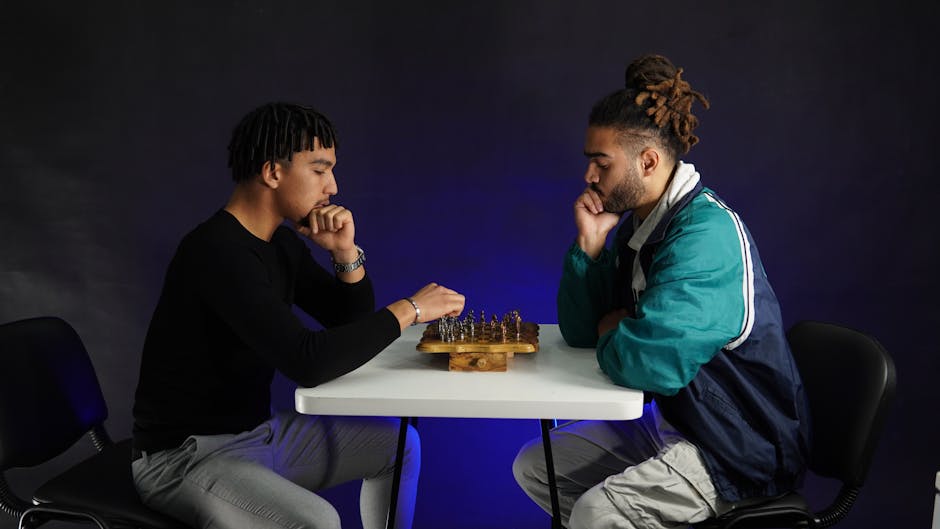Two adults deeply engaged in a strategic chess match indoors, fostering concentration.