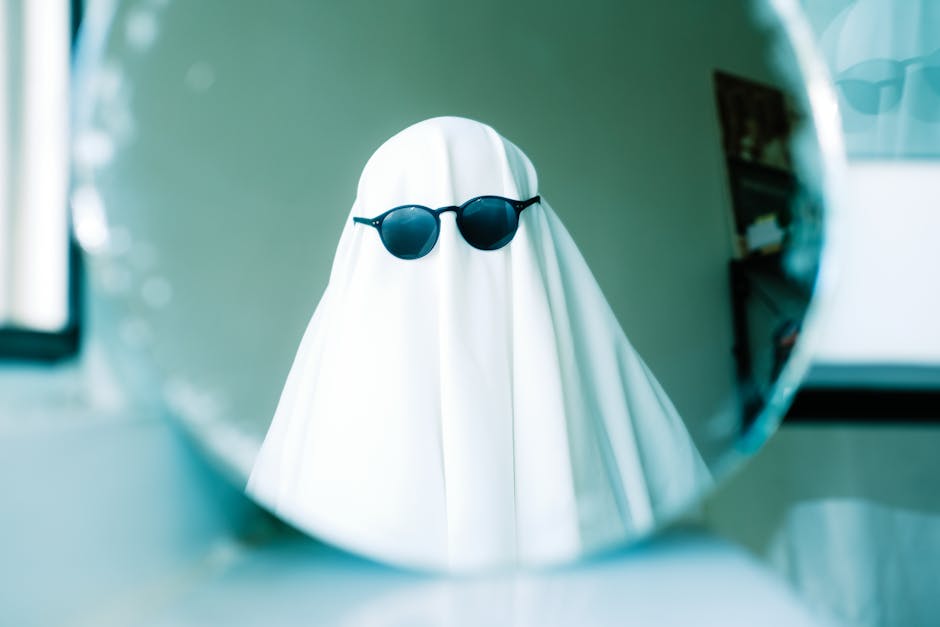 A ghostly figure wearing sunglasses captured in a mirror reflection, perfect for Halloween themes.