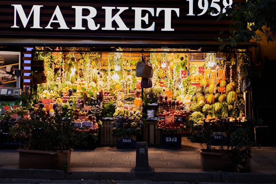 Vibrant market stall in İstanbul displaying a variety of fresh fruits and vegetables at night.