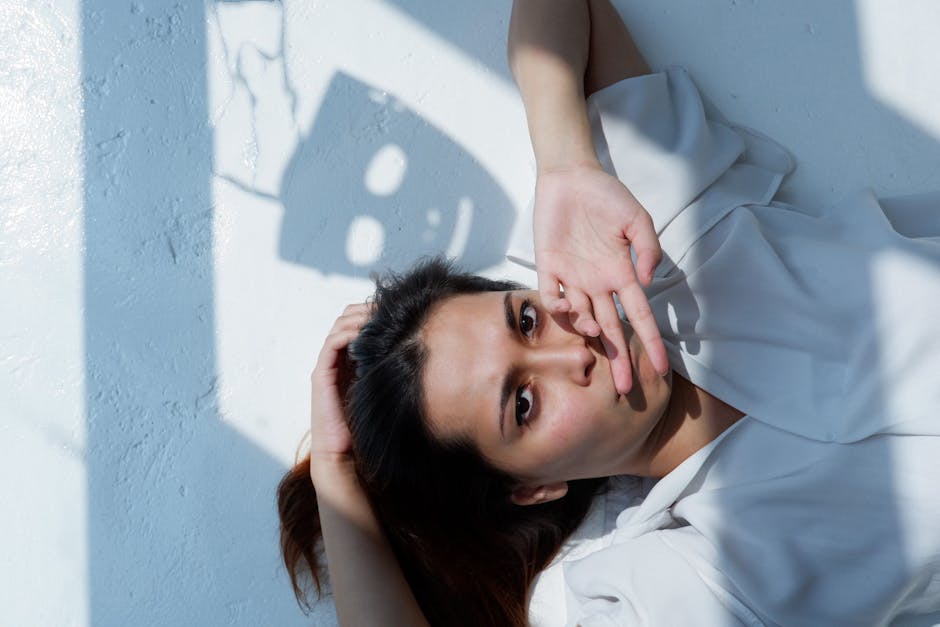 Stylish portrait of a woman with playful shadows on a bright surface in Singapore.