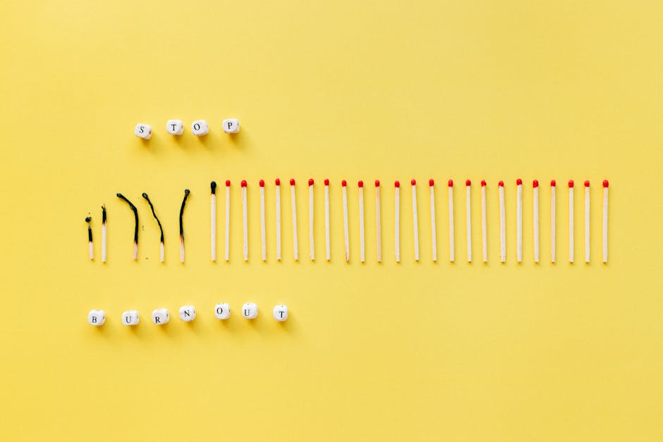 Burned and unburned matches arranged on a yellow background spelling 'Stop Burnout'.