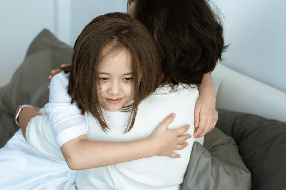 A touching moment of love and affection between a mother and her daughter sharing a warm hug.