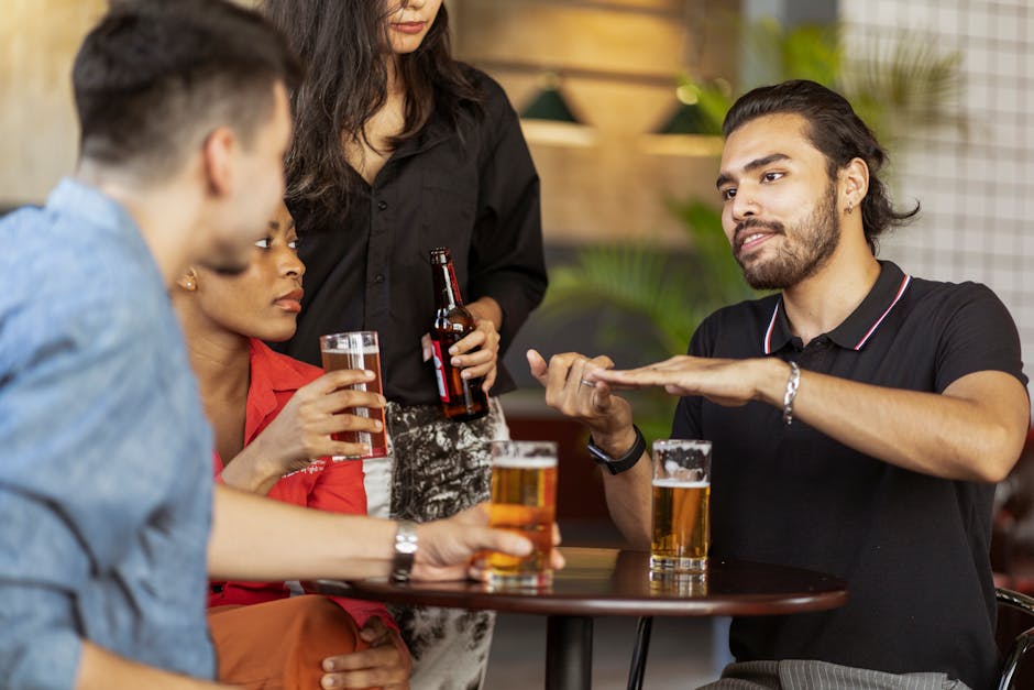 A group of friends relaxing and chatting over drinks in a cozy indoor setting.
