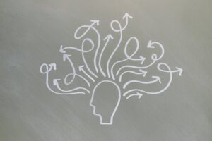 Conceptual chalk drawing illustrating mental health challenges with arrows representing thoughts.