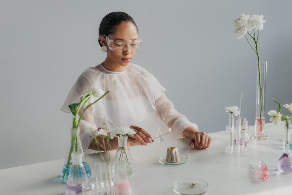 Scientist experimenting with flowers and glassware, blending science and nature in a studio setting.