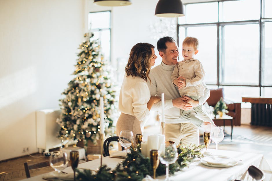 Family enjoying a joyful moment by the Christmas tree in a cozy holiday setting.