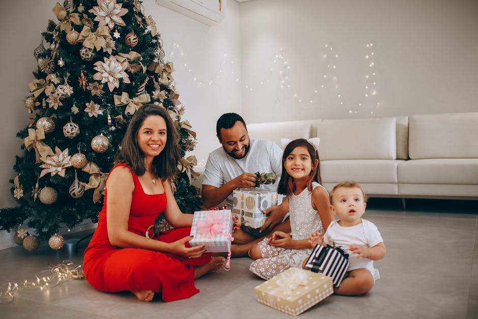 Happy family exchanging gifts by the Christmas tree, enjoying the festive season indoors.
