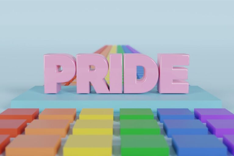 A vibrant 3D render featuring the word 'PRIDE' in pink with a rainbow path and colorful background.