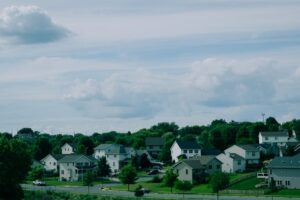 Picturesque suburban houses beneath a blue sky with clouds in Wisconsin.