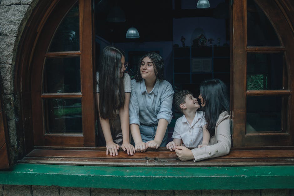 A family spending quality time by a window, engaged in conversation and smiles.
