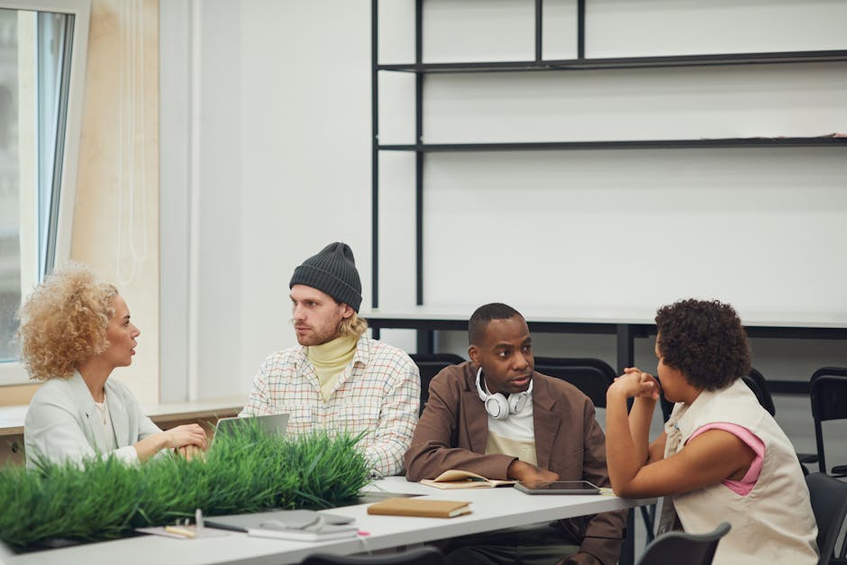 A diverse group of colleagues engaging in a collaborative meeting in a modern office setting.