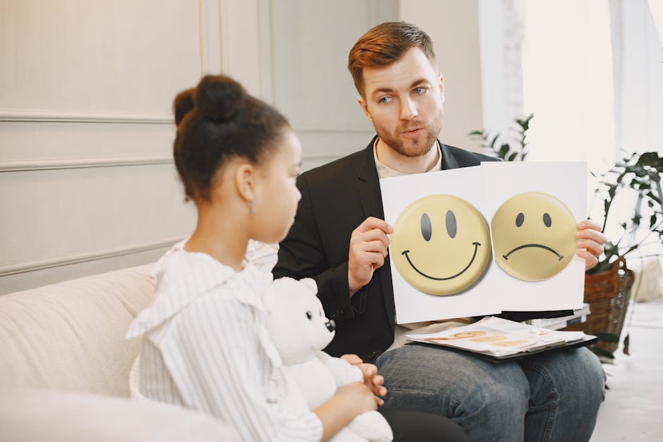 A therapist uses emotion cards to help a child express feelings during a counseling session.