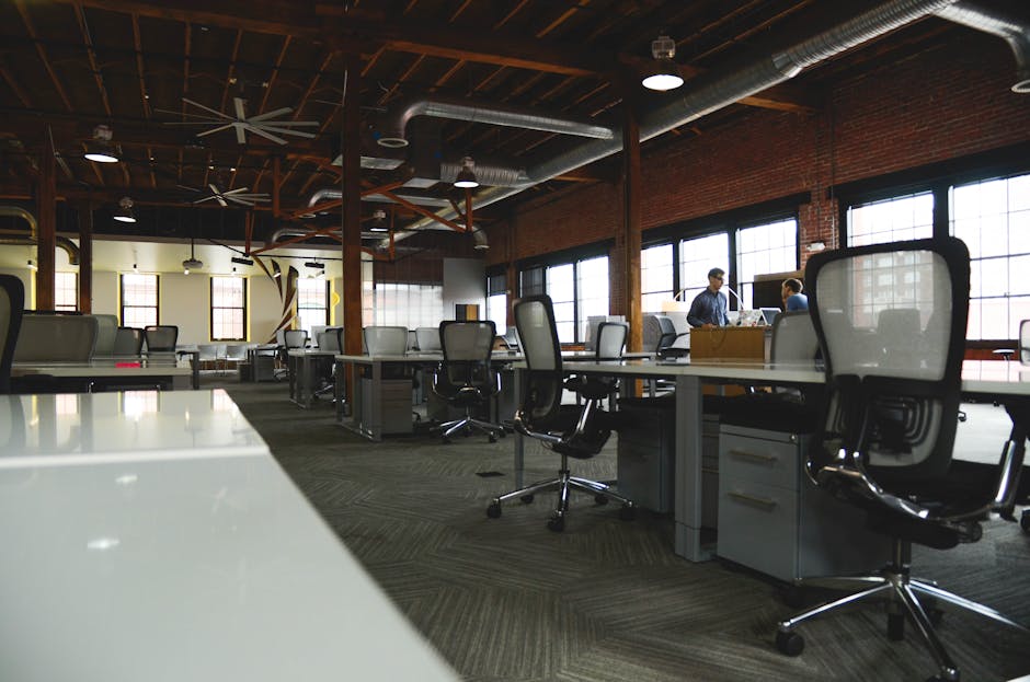 Open-plan industrial coworking space with modern design and natural lighting.