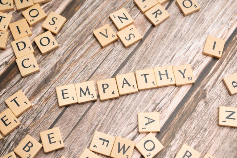 Wooden letter tiles spelling 'empathy' on a wooden background conveying connection.