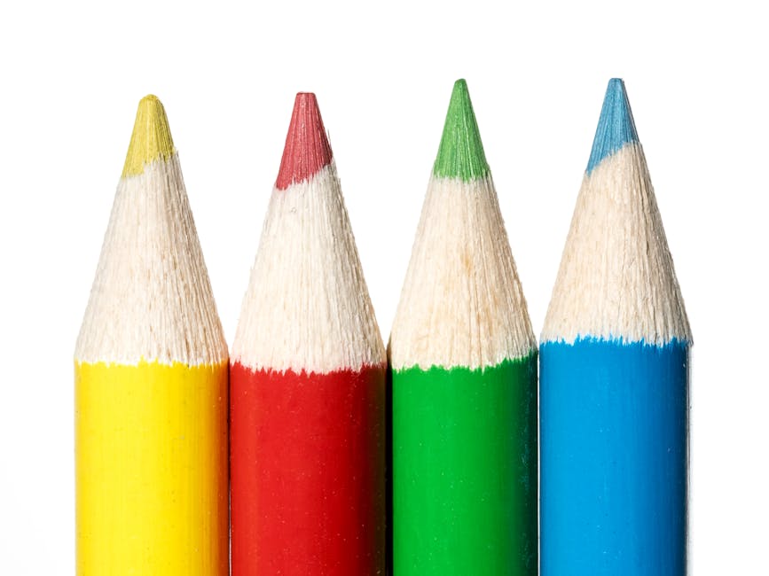 Vibrant close-up of colored pencils with yellow, red, green, and blue hues on a white background.
