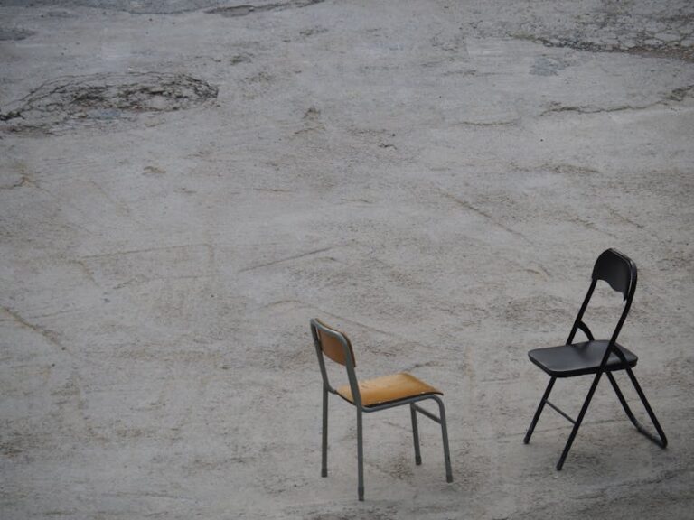 Minimalist photograph featuring two chairs on a concrete surface in Hong Kong.