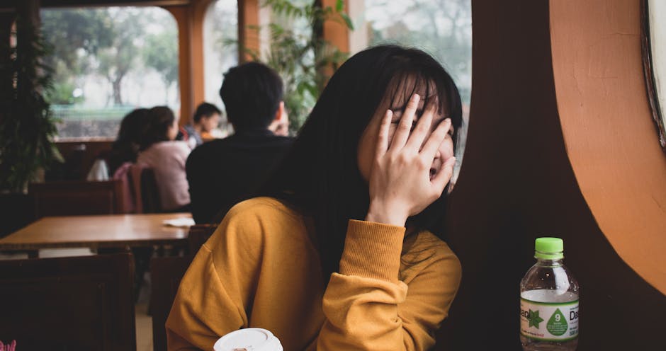 Playful moment indoors with a shy young woman in a Hanoi cafe.