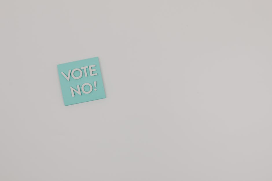 Simple image of a 'Vote No!' message on a gray surface with ample copy space.