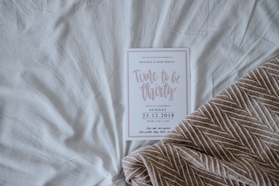A chic invitation card for a 30th birthday celebration resting on a soft fabric background.