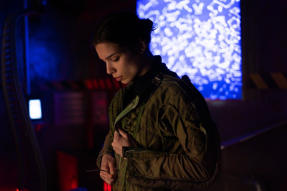 A woman in a sci-fi environment wearing a futuristic jacket, surrounded by technology and lights.