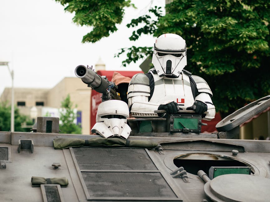 A sci-fi character in armor riding an armored vehicle outdoors.