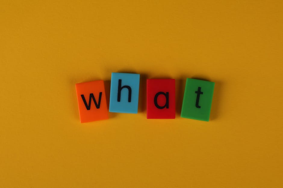 Colorful blocks spelling 'What' on a bright yellow background, creating a playful and bold composition.